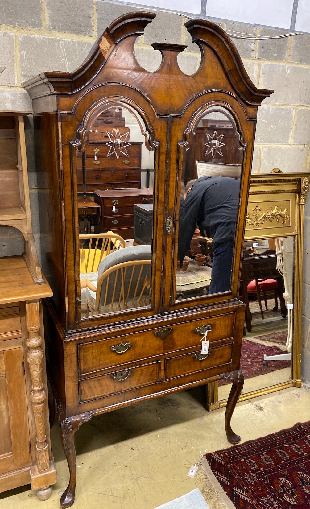 A Queen Anne revival walnut mirrored two door side cabinet, width 92cm, depth 51cm, height 206cm